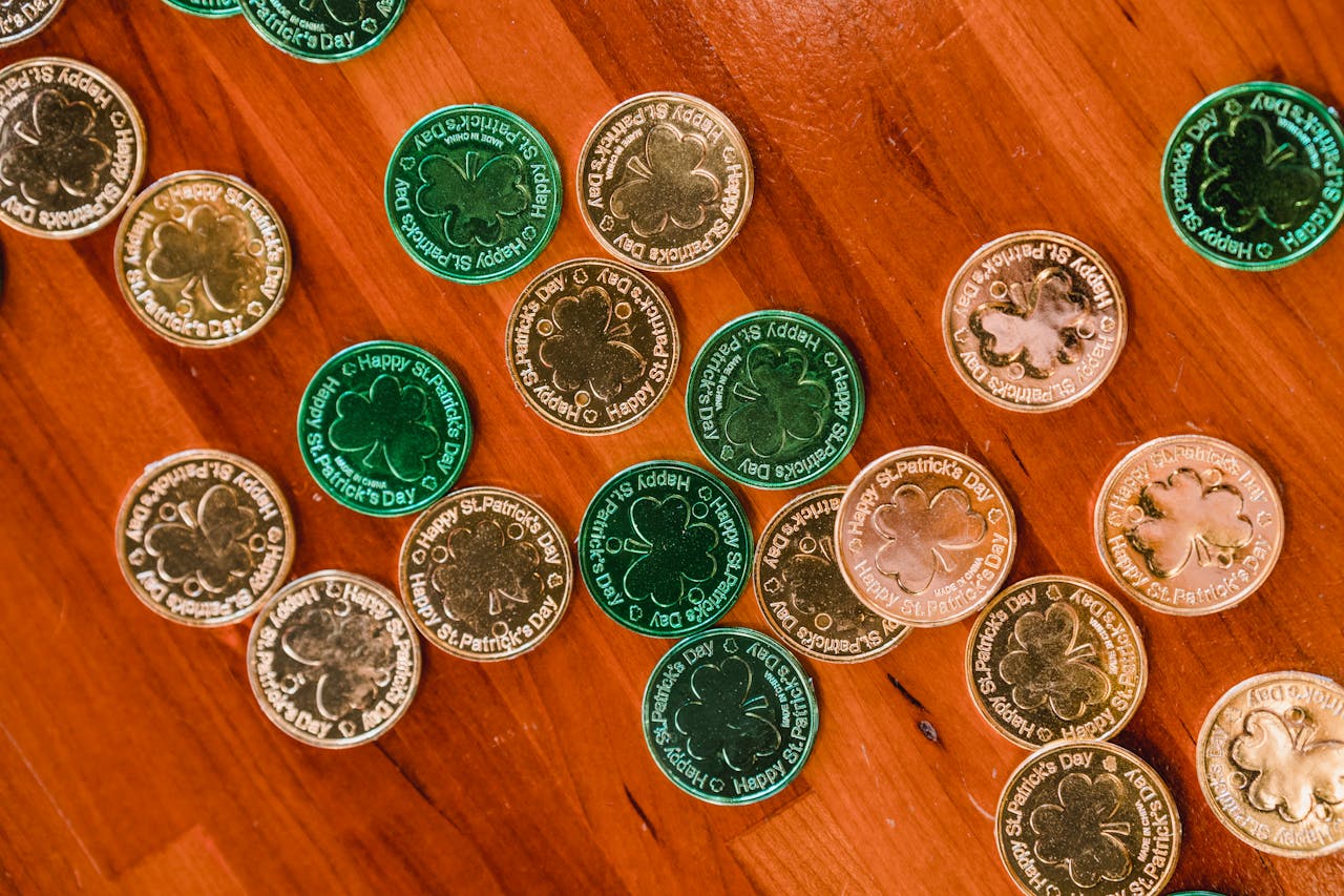 about-01 Top view of many sparkling green and golden festive St Patricks day coins placed on timber floor